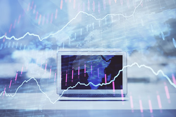 Forex graph hologram on table with computer background. Multi exposure. Concept of financial markets.