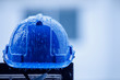© CStock - heavy rain and construction safety helmets, blue hard safety helmet and raining
