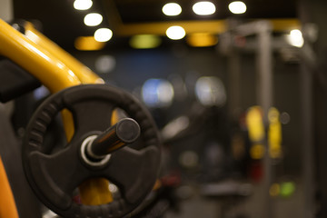 Gym Instruments cycles, handles bar inside a gymnasium with beautiful light  shot in low depth of field. Fitness