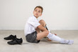© 303Photos.com - soccer boy sitting on floor