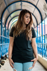 Wall Mural - Woman wearing black t shirt posing at footbridge, suitable for mock up template, etc.