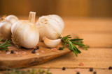 Fototapeta Miasto - garlic and drunkenness on a wooden background, food and cooking saver, recipe book