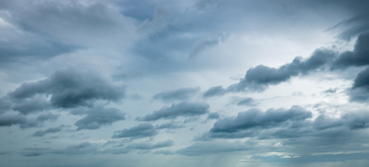 Wall Mural - Dark dramatic sky and clouds. Background for death and sad concept. Gray sky and fluffy white clouds. Thunder and storm sky. Sad and moody sky. Nature background. Dead abstract background. Cloudscape.