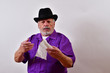 © Joe - Stern old man holding an empty roll of toilet paper. Dapper Old man holding an empty roll of toilet paper. Sharp dressed senior man with an empty roll of toilet paper.