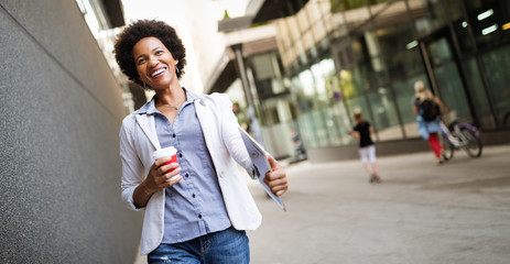 Wall Mural - Beautiful happy professional business woman smiling happy with tablet outdoor