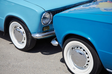 Two blue cars collided against one another - as a symbol of a car accident on the road