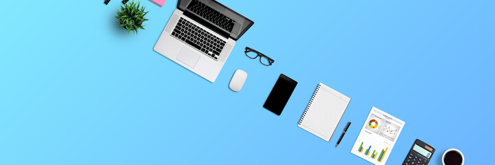 Top view office desk and supplies, with copy space. Creative flat lay photo of workspace desk/Panoramic banner blue background