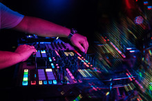 Hands DJ Mixing And Playing Music On A Professional Controller