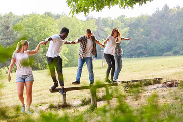 Wall Mural - Group of young people exercises teamwork