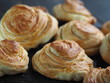 Homemade pastries buns rich on the kitchen dark cutting board, holiday and everyday food.