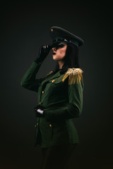 portrait of a young woman in uniform, holding her cap by the hand
