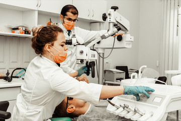 Two dentists treat a patient. Professional uniform and equipment of a dentist. Healthcare Equipping a doctor’s workplace. Dentistry