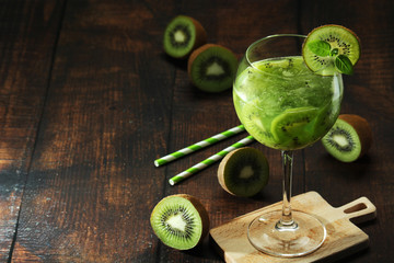 A glass with kiwi cocktail	