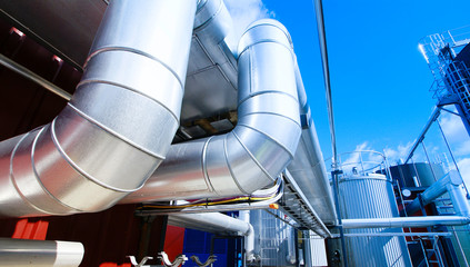 Wall Mural - Industrial zone, Steel pipelines and valves against blue sky