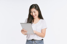 Young Beautiful Asian Woman In Business Office Standing Use Tablet In Hand, Thai Girl Enjoy Browsing For Online Shopping Store With Copy Space For Advertisement, On Isolated White Background