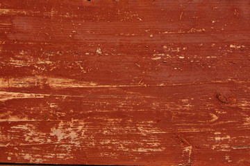 wooden wall of old house, painted red color, natural wood texture or background