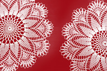 Two Handmade Crocheted White Lace Napkins Isolated On Red Background