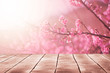 Spring seasonal of pink sakura branch with wooden table stand ,flower background