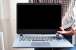 © Wasan - A young man presents a laptop with a blank screen for your work.