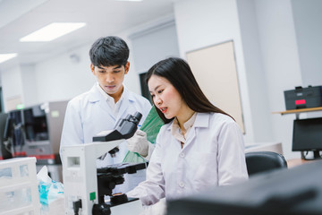 two medical scientist consult at microscopic analysis in medical laboratory