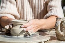 Womans Hands Working Of Ceramics On Potter Wheel Closeup