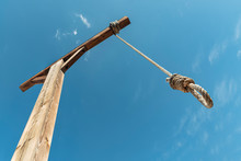 Gallows Against Blue Sky. Hanging Rope As A Way To Punishment