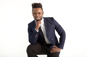 Wall Mural - young handsome african man in a suit on a white background