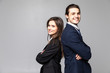© F8  \ Suport Ukraine - Two young business people standing back to back with hands crossed isolated on grey background