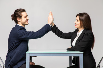 Wall Mural - Businesspeople man and woman giving each other high five for successful business isolated on white background