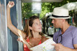 © auremar - woman and man checking a bus at bus stop