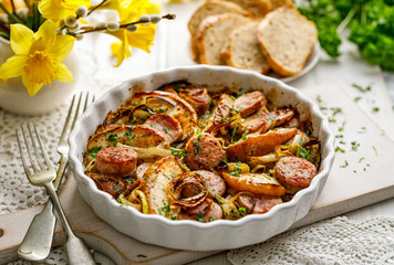 Wall Mural - Sausage casserole with the addition of onion leeks and apple particles served in dish