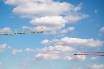 Wall Mural - Two cranes and cloudy sky. Details. White and gray clouds