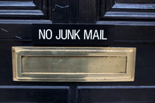 House Letterbox With 'No Junk Mail' Sign And Junk Mail
