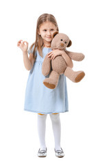 Poster - Cute little girl with teddy bear showing OK gesture on white background