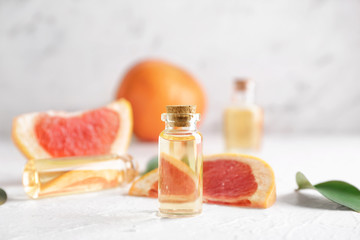 Bottles of grapefruit essential oil on table