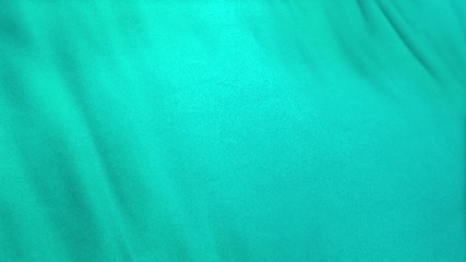 Wall Mural - turquoise flag cloth in full frame with selective focus. Seamlessly looping 3D animation of aqua colored garment with clean natural linen texture for background banner or wallpaper use.