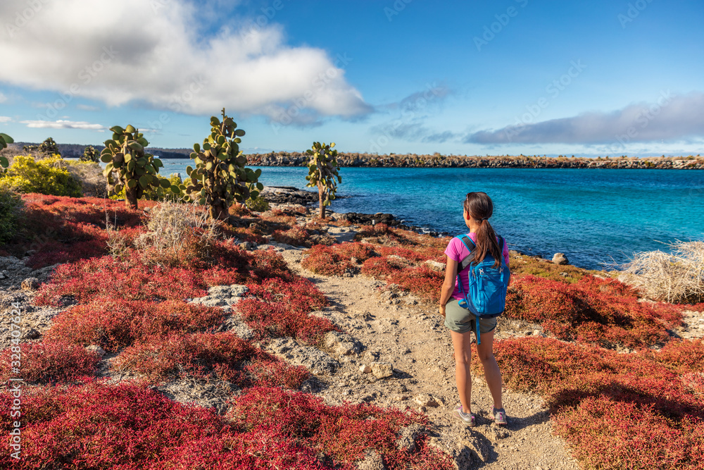 Galapagos tourist on adventure hiking enjoying landscape and animals on ...