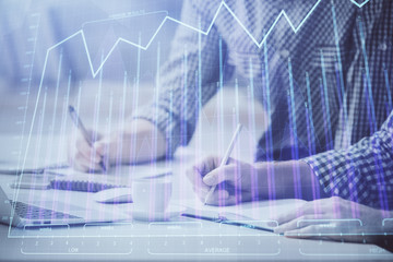 Multi exposure of forex chart with man working on computer on background. Concept of market analysis.