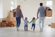canvas print picture - Happy family with children moving with boxes in a new apartment house.