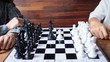 Tow business women play chess game. Demonstrate competition to success playing, the business strategy.