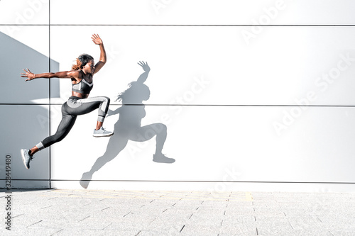 Fotografía Runner woman in motion outdoors in the city