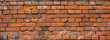Old brick wall. Brickwork from an old brick in a rustic style. The structure and pattern of the destroyed stone wall. Copy space