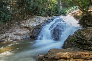 view of silky waterfall flowing on arch rocks around with green forest nature background, Mae Sa Waterfall, Mae Sa Waterfall National Park, Chiang Mai, northern Thailand.