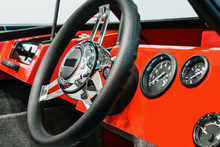 Steering Wheel On The Dashboard Of A Boat Or Motor Boat. Focus On The Middle Of The Steering Wheel
