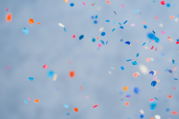 colorful confetti falling on a holiday on a blue background
