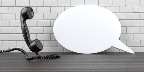 Wall Mural - telephone handset with a white speech bubble on the table. 3d illustration.