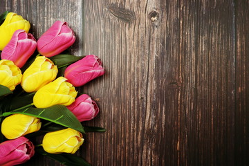 Canvas Print - Bouquet of pink and yellow tulips flowers with space copy on wooden background