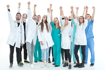 top view. a group of smiling doctors pointing at you.