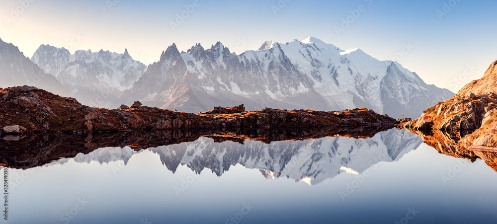 Incredible view of clear water and sky reflection on Chesery lake (Lac De Cheserys) in France Alps. Monte Bianco mountains range on background. Landscape photography, Chamonix. - obrazy, fototapety, plakaty 