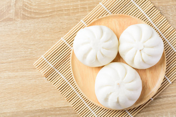 Canvas Print - Steamed buns on wooden plate ready to eating, Asian food, Top view